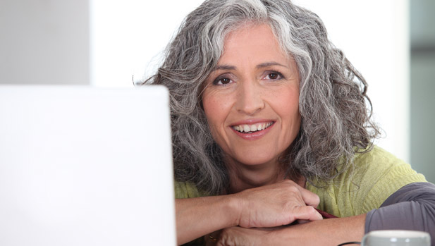Woman smiling and happy with the money she saved now that she can shop and compare online